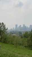 Haze Shrouds Calgary Skyline as Wildfire Smoke Returns to Southern Alberta