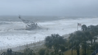 Hurricane Ian's Rough Seas Batter Washed-Up Boat on South Carolina Beach