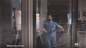 TV gif. Ryan Eggold as Max Goodwin on New Amsterdam runs in his scrubs, pushes through a revolving door, and continues to sprint outside.