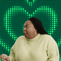 Sponsored gif. Woman grins broadly with wide eyes as she accepts a to-go cup of Starbucks iced coffee. Green hearts radiate behind her. Text reads, “For me?!”
