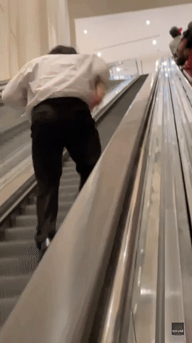 Man Runs Up Lengthy Downbound Escalator 