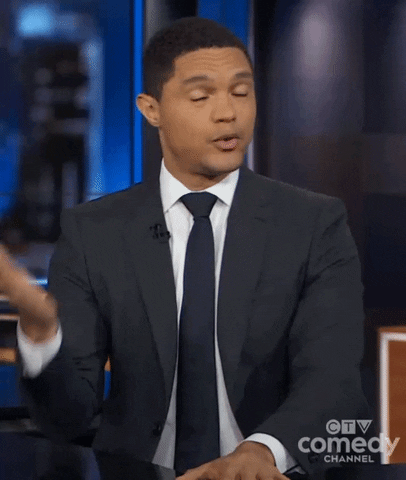 TV gif. Trevor Noah as host of The Daily Show closes his eyes and takes a deep breath as he shakes his head and fans himself with 1 hand.