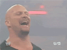 Sports gif. Stone Cold Steve Austin fakes a laugh and then his face turns serious as if to say, “Not funny.”