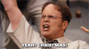 The Office gif. Rainn WIlson as Dwight Schrute has his hands in the air and one hand in a rock n roll symbol. Like a battle cry, he yells, “Yeah, Christmas!” 