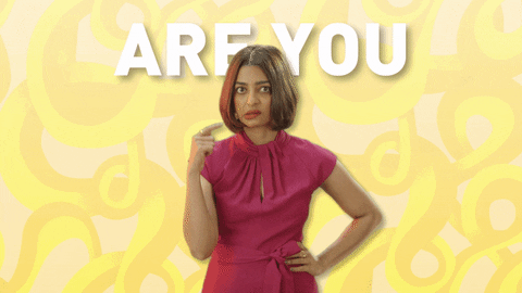 Celebrity gif. Radhika Apte makes a spiral gesture around her ear and looks annoyed. Text, "Are you mad!"