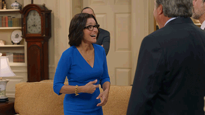 TV gif. Julia Louis-Dreyfus as Selina and Kevin Dunn as Ben in Veep. They stand in the middle of the Oval Office and give each other a high five, jubilated at what they've done.