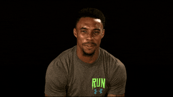 Sports gif. Morgan Burnett covers his mouth and leans back in a surprised reaction.
