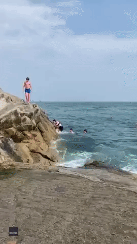 Taking the Plunge! Newlyweds Dive Into Sea Wearing Full Wedding Garb