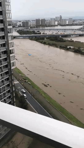 Debris Flows Down River as Typhoon Lan Moves Over Tokyo