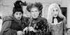 Movie gif. Sarah Jessica Parker as Sarah Sanderson, Bette Midler as Winifred Sanderson, and Kathy Najimy as Mary Sanderson in Hocus Pocus glare at something with wide eyes and they all take a cautious step backwards.