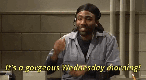 SNL gif. Donald Glover is dressed like an inmate, sitting at a desk in what looks like prison, wearing a dew rag and a hands free headset. He leans back with a smile and says happily, "It's a gorgeous Wednesday morning!"