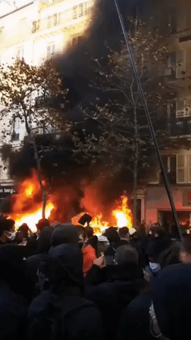 Fires Burn Near Bastille Square in Paris During Protests Against Security Bill