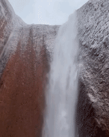 Water Rushes Down Uluru's Rock Face Amid Heavy Rainfall