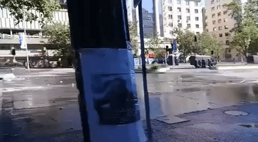 Police Use Water Cannon to Clear Santiago Streets During Clashes With Protesters