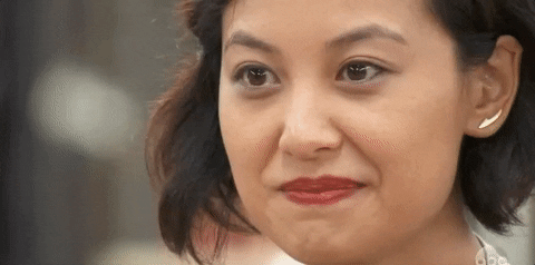 Reality TV gif. Stephanie Chen in The Great American Baking Show cracks a wide smile.
