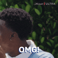 Sponsored gif. Man holds his fist up to his face. He looks pleasantly shocked. Text reads, “OMG!”