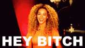Celebrity gif. Beyonce smiles at us and cocks her head to the side, looking sweet and upbeat as she says, "Hey bitch," which appears as text.