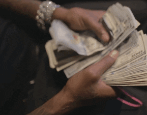 Video gif. Somebody's hands shuffle through a thick stack of 100 dollar bills while a blingy bracelet adorns their wrist.