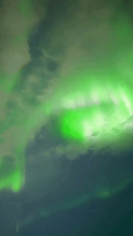 Aurora Borealis Dazzle Behind Clouds in Alaska