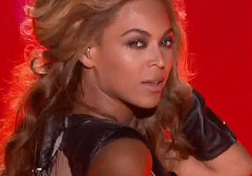 Celebrity gif. Beyoncé blows a kiss during her Super Bowl Halftime Show performance in 2013.