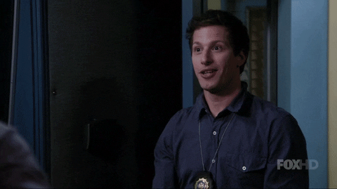 TV gif. Andy Samberg as Jake in Brooklyn nine nine imitates an explosion with his mouth and by throwing his hands in the air. 