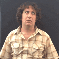TV gif. Oliver Cooper as Wheeler from Red Oaks. He does one big shrug of his shoulders as he sighs and looks to the side, annoyed. 