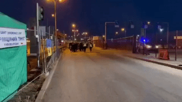 Ukrainian Refugees Cross Polish Border on Foot Before Boarding Bus to Sweden