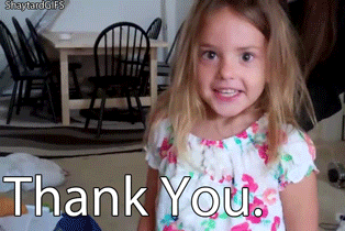 Video gif. Kindergarten aged girl stares at us with big, wide eyes, and says, “Thank you.”