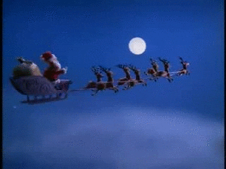 Stop-motion gif. From "Rudolph the Red-Nosed Reindeer," reindeer pull Santa in his sleigh through the sky into the distance under a full moon.