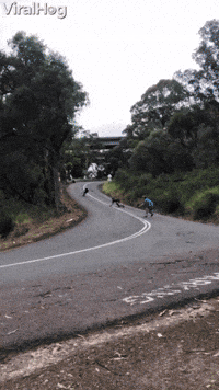 Downhill Skateboarder Takes Out Cameraman