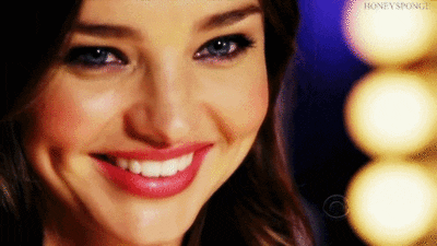 Celebrity gif. Close up on Miranda Kerr's face as she smiles and winks.