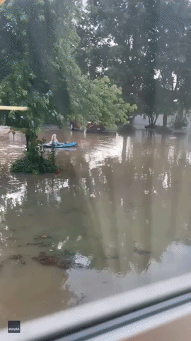Woman Kayaks in Floodwater After Heavy Rain Hits Northern Arkansas