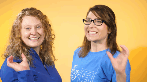 Two women creating a heart with their hands