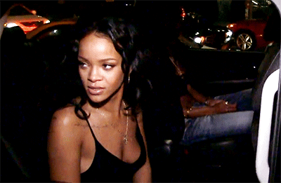 Celebrity gif. Looking very annoyed, Rihanna glares as she rolls up her car window.