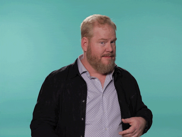 Celebrity gif. Jim Gaffigan smiles and tries to throw us a wink but fails. He gathers himself and tries again, failing still but throwing in a finger gun.