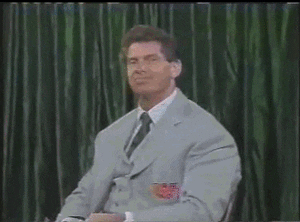 Celebrity gif. Vince McMahon smoothly puts on sunglasses with star stickers on the lens while looking at us.