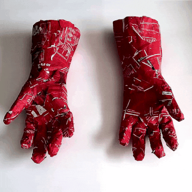 Video gif. Mechanical hands covered in red food wrappers wiggle their fingers like they’re tickling the air.