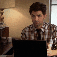 Parks and Recreation gif. Adam Scott as Ben sits at a desk with a laptop. In a series of cuts of the same shot repeated, there's a closeup of his face as he looks at us confused, then he shakes his head, putting his hands out as if to say, "what?"