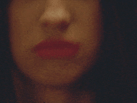 Video gif. Closeup of Olivia Rodrigo repeatedly pulling her chin back and looking off with an angry, pouty expression, eyes staring daggers at something offscreen.