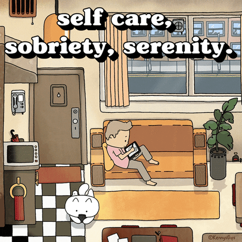 Digital art gif. Illustrated scene of a man relaxing at home on his couch, doodling serenely on a tablet. On the floor next to him, the man's cat wags its tail happily. Text, "Self care, sobriety, serenity."