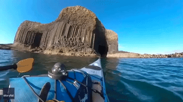 Kayaker Explores Narrow Passage of Stunning Scottish Sea Cave