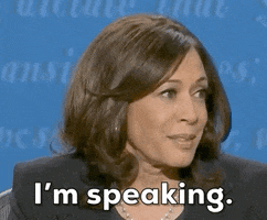 TV gif. Then-vice presidential candidate Kamala Harris is seated for the 2020 vice presidential debate. She smiles to mask her annoyance at an interruption from her debate opponent then-Vice President Mike Pence and says "I'm speaking" while nodding. 