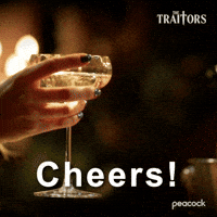 Sponsored gif. Two hands clink two champagne coupes together. Text reads, “Cheers!” In the upper right corner is the logo for the show The Traitors.