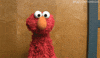 TV gif. Elmo from Sesame Street tilts his head and shrugs as if to say, "I dunno."