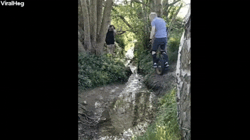 Man Trying to Jump Small Stream on Unicycle Prevai