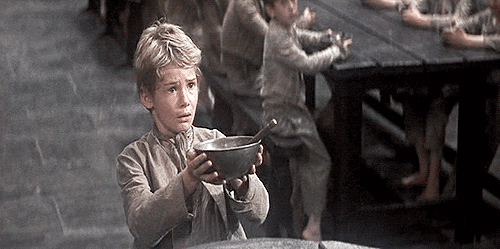 Movie gif. John Howard Davis as Oliver in Oliver Twist. He looks forlorn as he holds an empty bowl out and begs for more food.