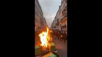 Fires Burn in Paris as Macron Addresses Pension Reform Protests