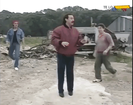 Video gif. A man is being approached by a bunch of other men and he begins swinging wildly, hitting them all to the ground. His fight style is clumsy, but affective.
