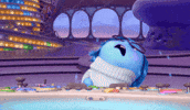 Movie gif. Sadness from Inside Out drops her head as if in despair as tear drops fly from her blue face. 