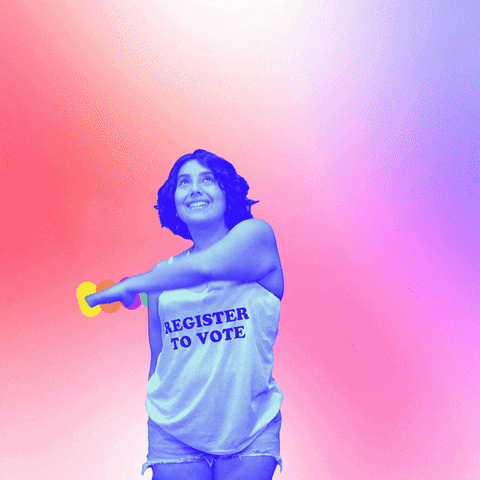 Video gif. Woman wearing a “Register to Vote” tank top over pink and purple background waves an arm over her head in an arch, revealing a sparkling rainbow that reads, “Revise su registro para votar.”